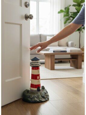 Lighthouse Cast Iron Door Stop With Red & White Stripes On Rocky Base